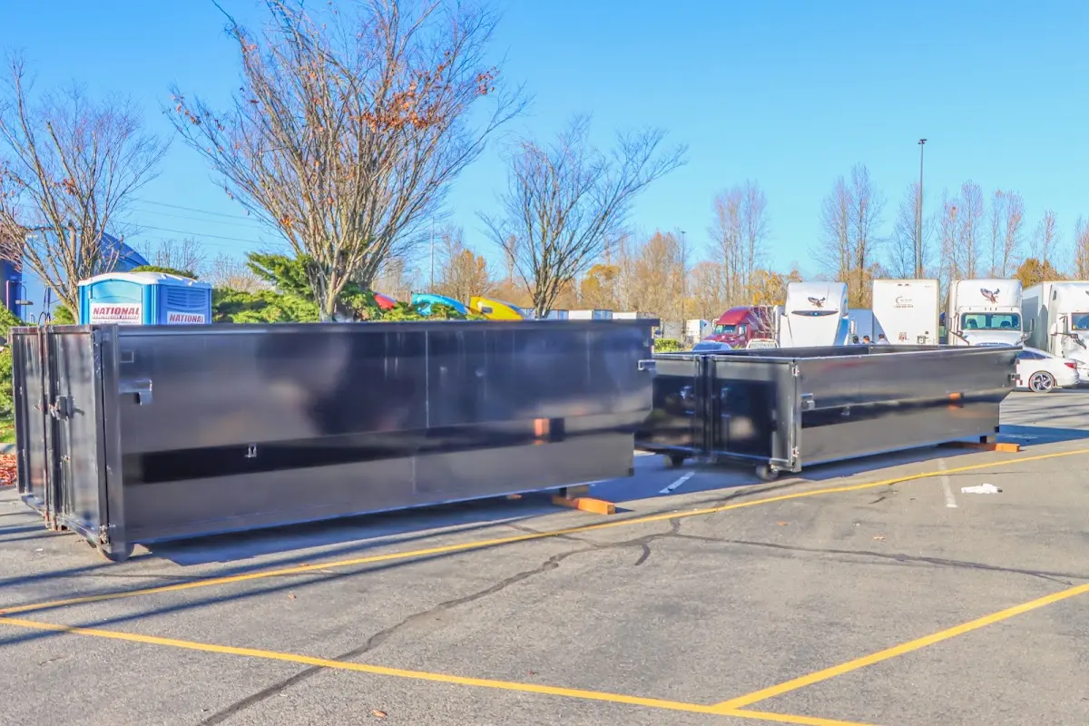 Professional dumpster rental service with roll-off container on residential driveway in Ipswich